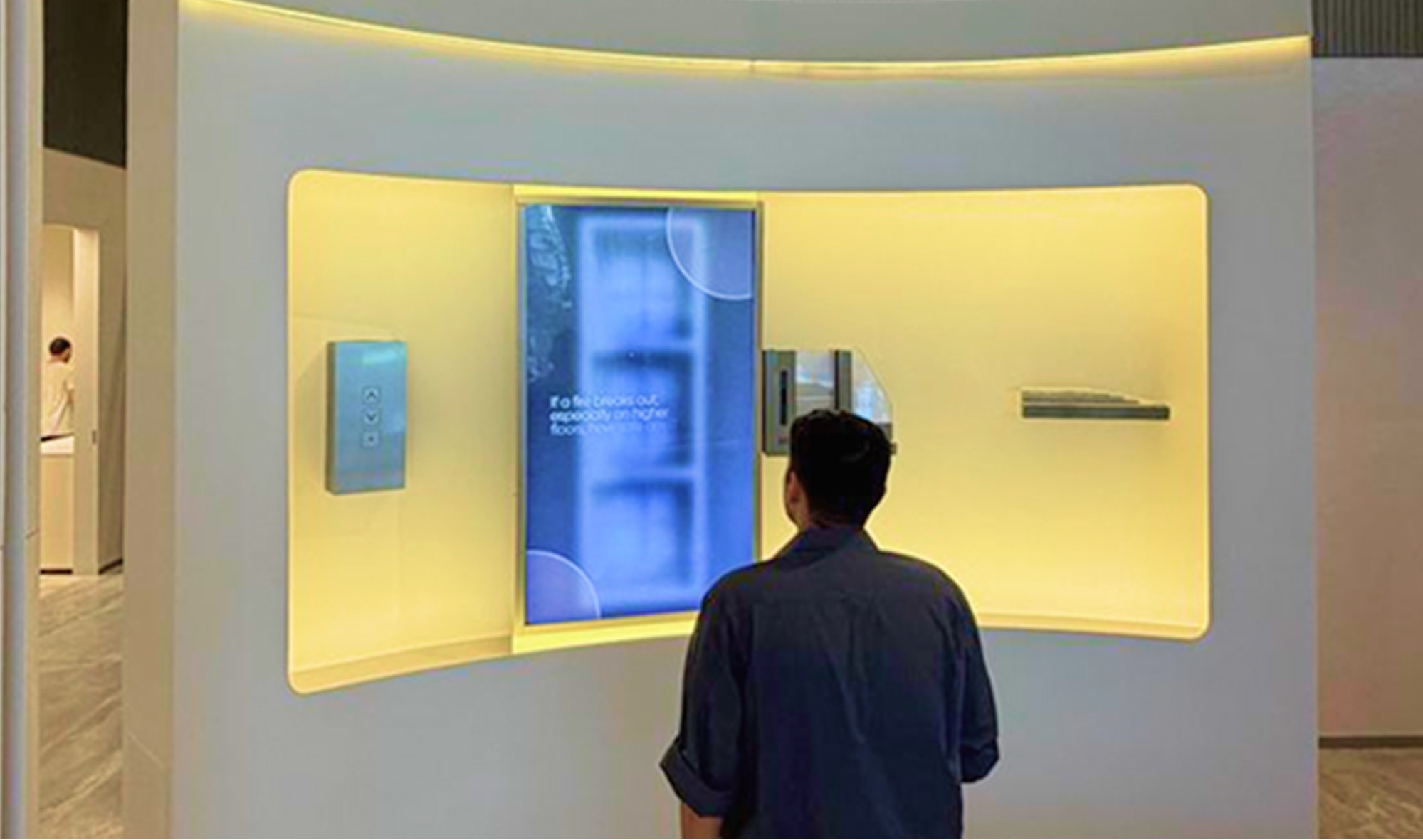 Visitor engaging with an immersive product-quality installation inside a real estate experience centre
